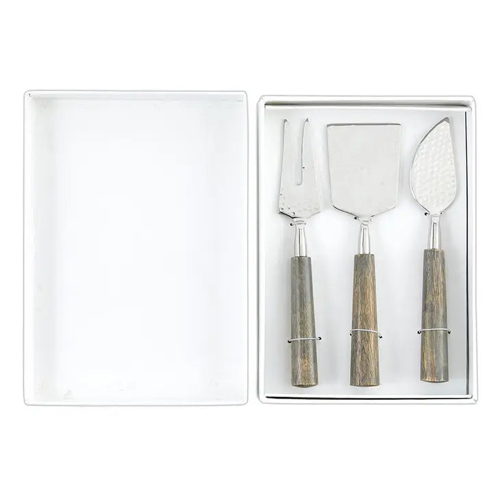 Set of three cheese knives with wooden handles in a white box on a white background