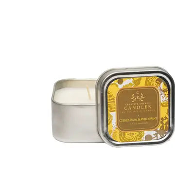 Citrus basil and wild mint lotion Candle in a decorative tin with a gold label on a white background