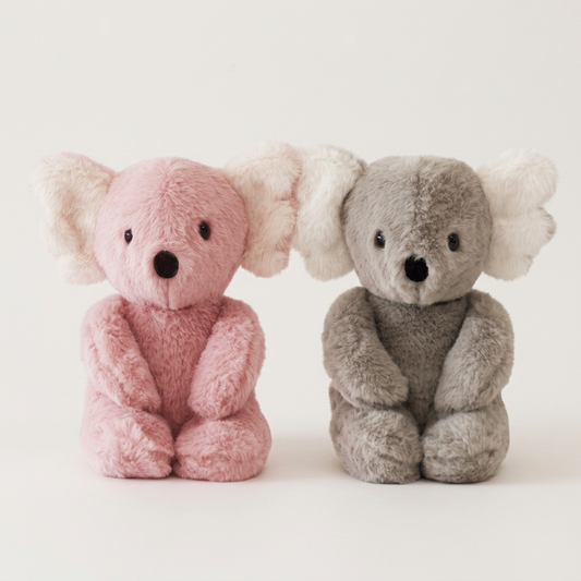 Two plush Alirose Koala stuffed animal toys, one pink and one gray, sitting side by side on a light background.
