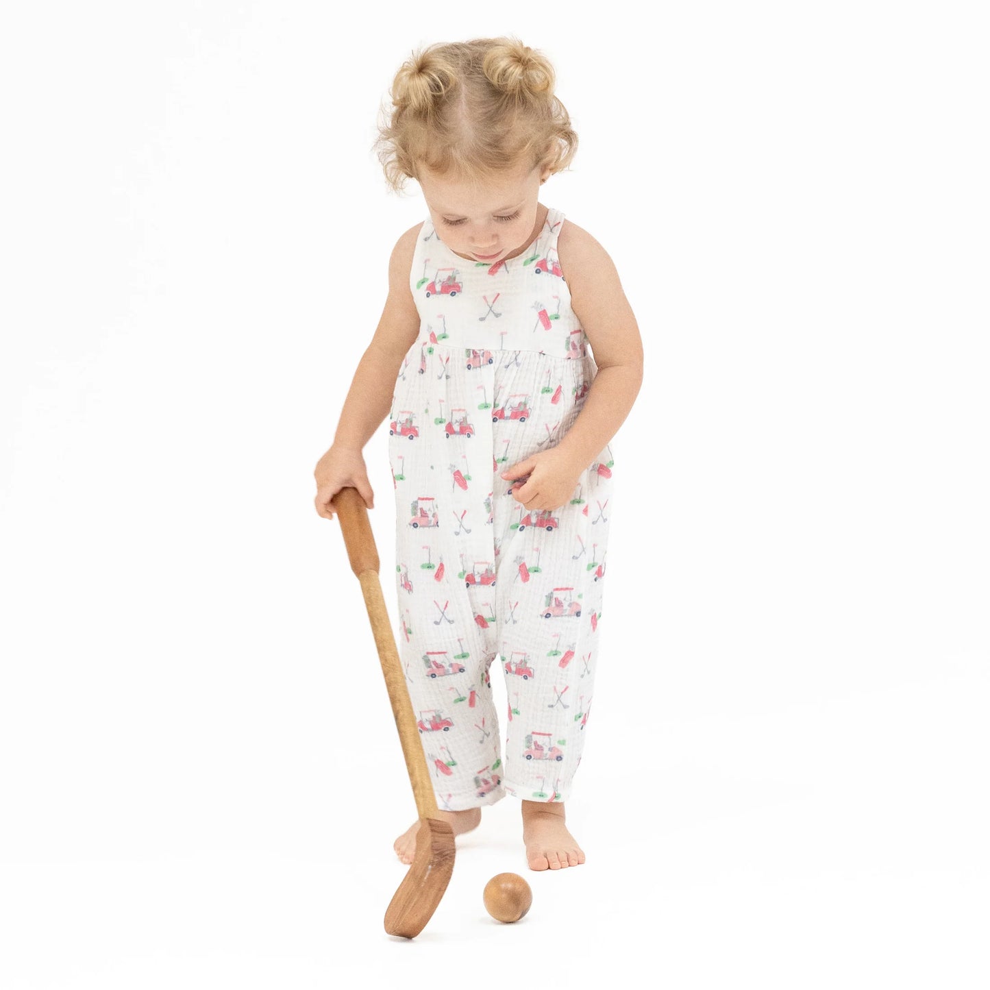 Girl wearing an Angel Baby Baby Golf Carts Tie Back Romper with pink golf cart and golf accessories design