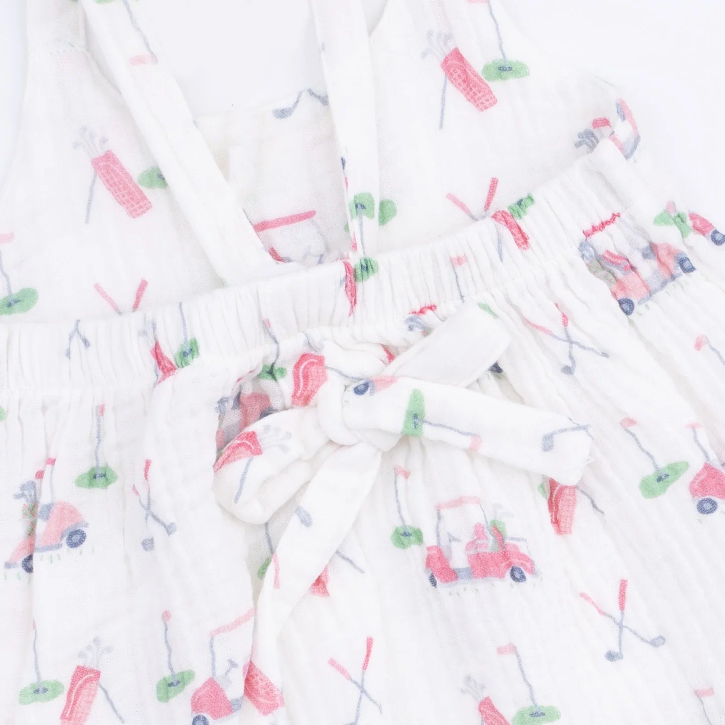Close up of the print on an Angel Baby Baby Golf Carts Tie Back Romper featuing the tie in the back