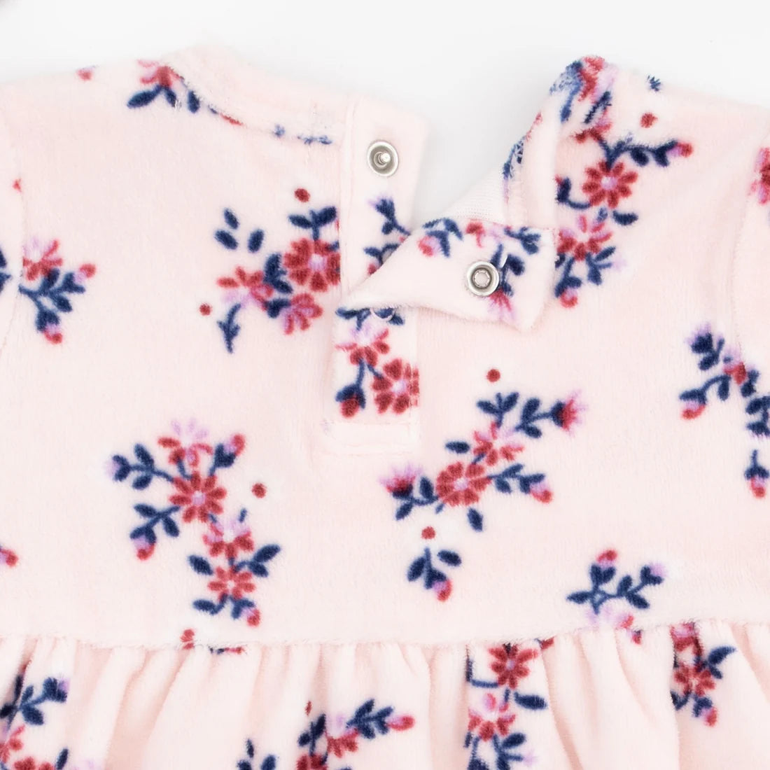 Close-up of a baby garm angel dear nora floral velour dress ent in soft blush pink fleece with a floral print in red and navy blue, featuring a snap-button collar.