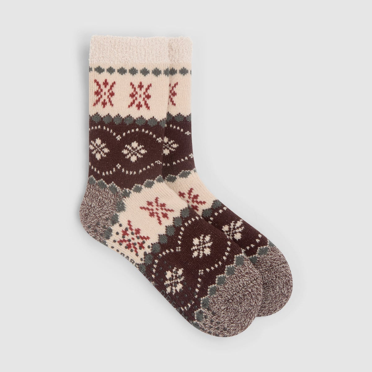 a pair of slipper socks in a brown and cream fair isle pattern