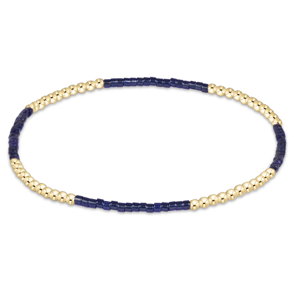 A beaded enewton gameday hope blissful  stretch bracelet featuring alternating strands of polished gold-toned round beads and dark navy blue rectangular beads, displayed on a clean white background.