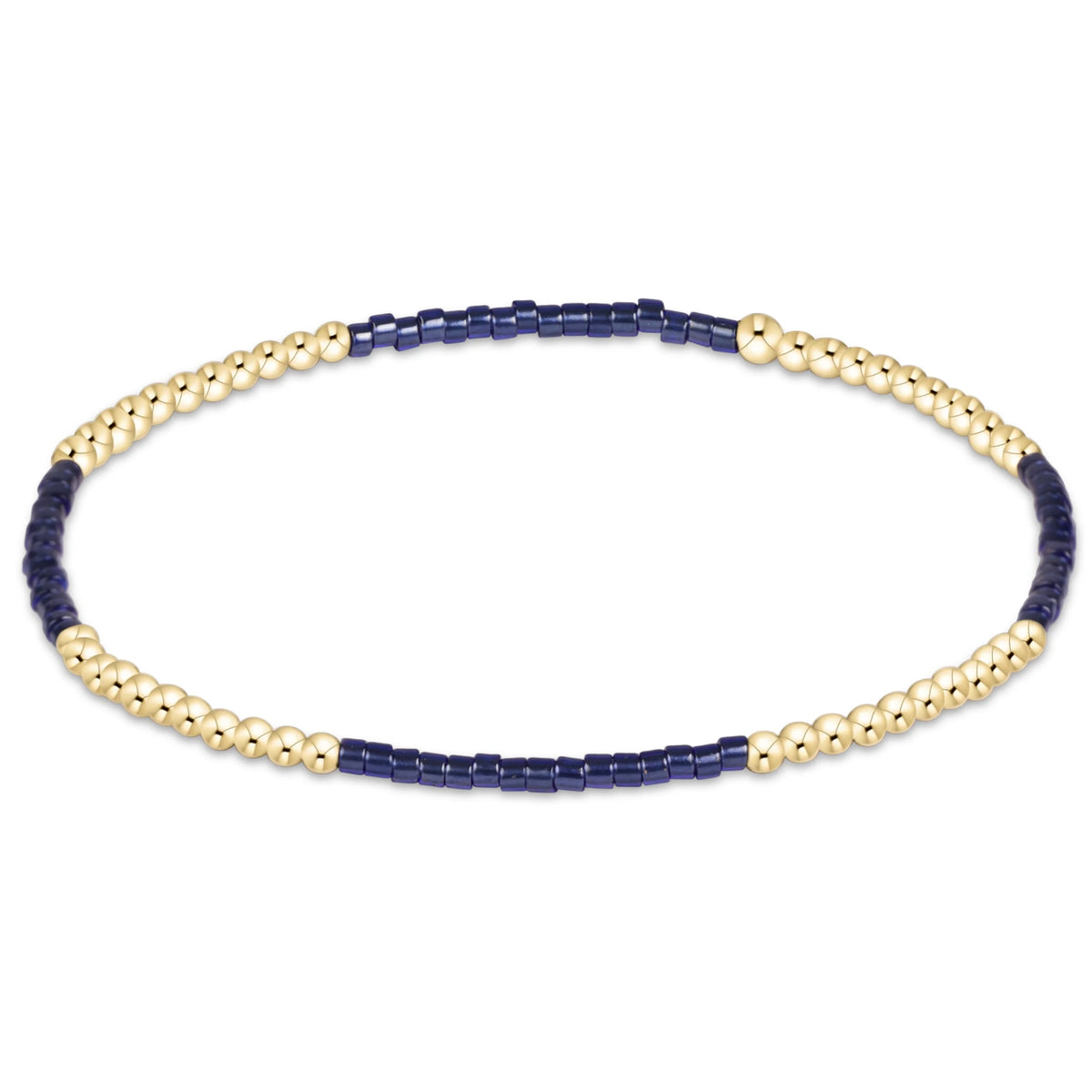 A delicate beaded enewton Hope Blissful Navy and gold bracelet featuring alternating sections of polished gold-toned round beads and dark navy blue cylindrical beads, displayed on a clean white background.