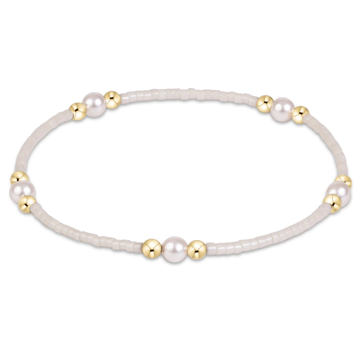 A delicate stretch enewton Hope Purpose Gold Milkshake  bracelet featuring a strand of tiny pale beads, accented with several large white pearls and polished gold spacer beads, shown on a clean white background.