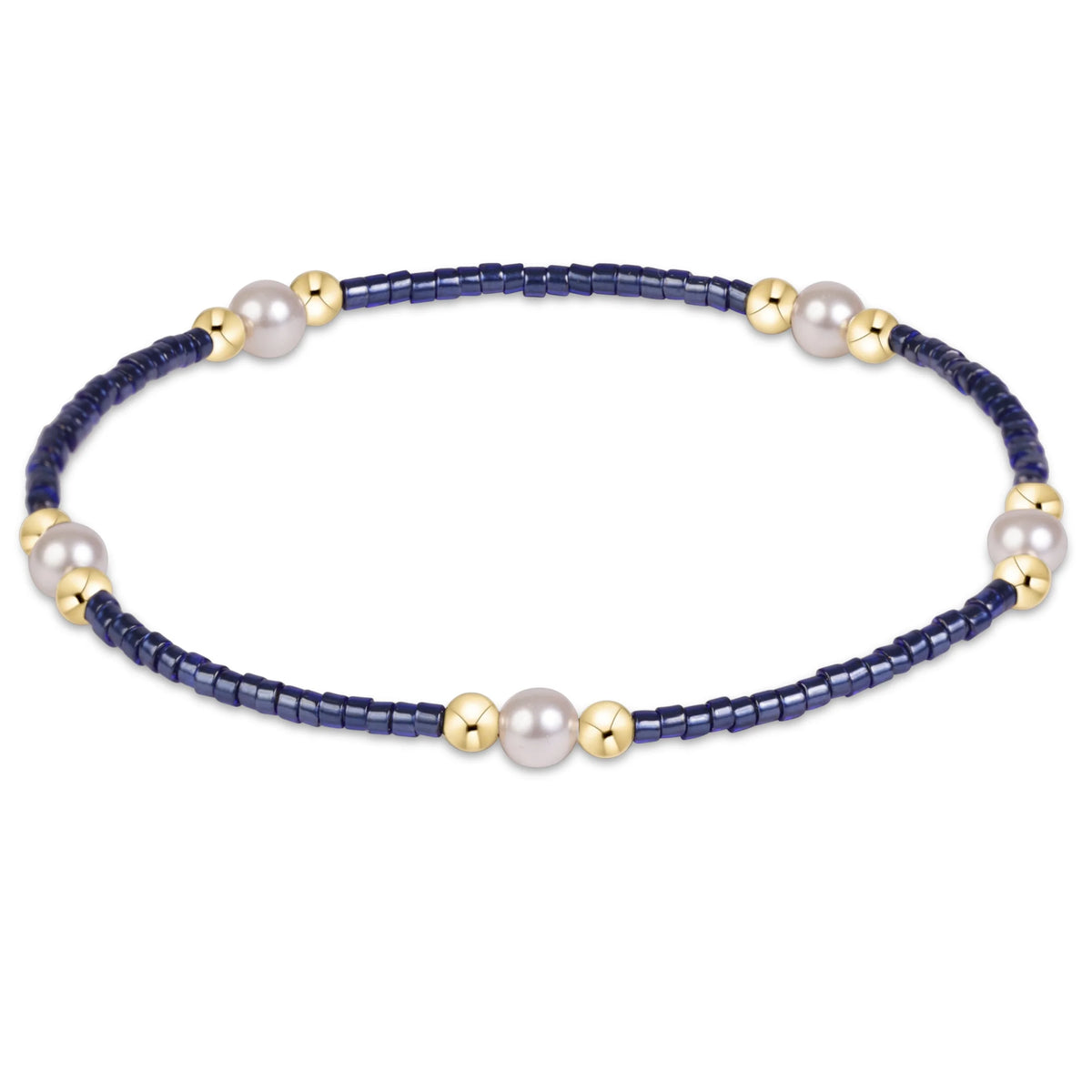 A beaded stretch enewton hope purpose pearl navy bracelet featuring dark navy blue faceted beads, white freshwater pearls, and polished gold spacer beads, shown on a clean white background.