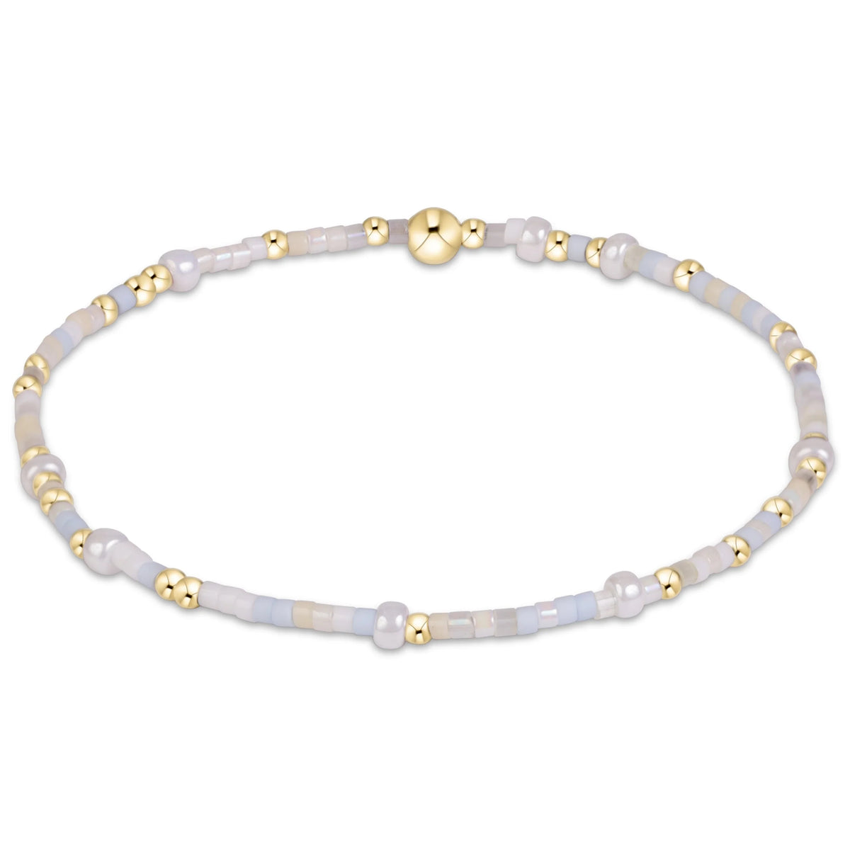 A delicate beaded enewton hope unwritten daydreaming bracelet featuring pale blue-gray agate beads, white pearl-like beads, and polished gold spacer beads, arranged in a circular shape on a solid white background.
