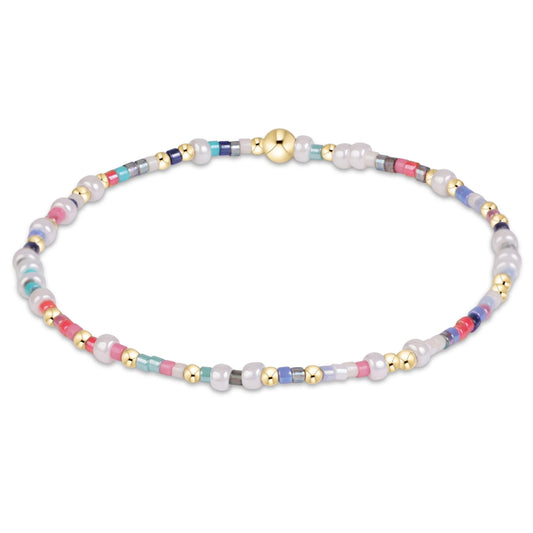 A beaded enewton hope unwritten That's a Wrap bracelet featuring white freshwater pearls, small gold spacer beads, and multi-colored glass beads in pastel shades of pink, blue, and green, arranged in a circular loop on a white background.