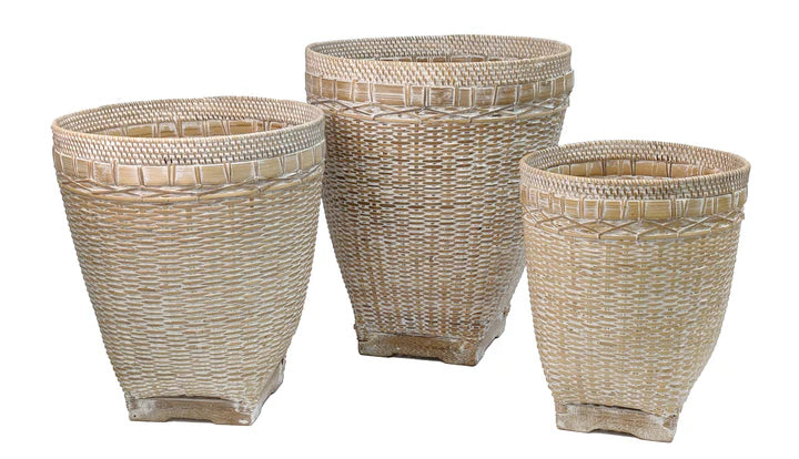 Three woven wicker baskets of different sizes by Banyan Designs