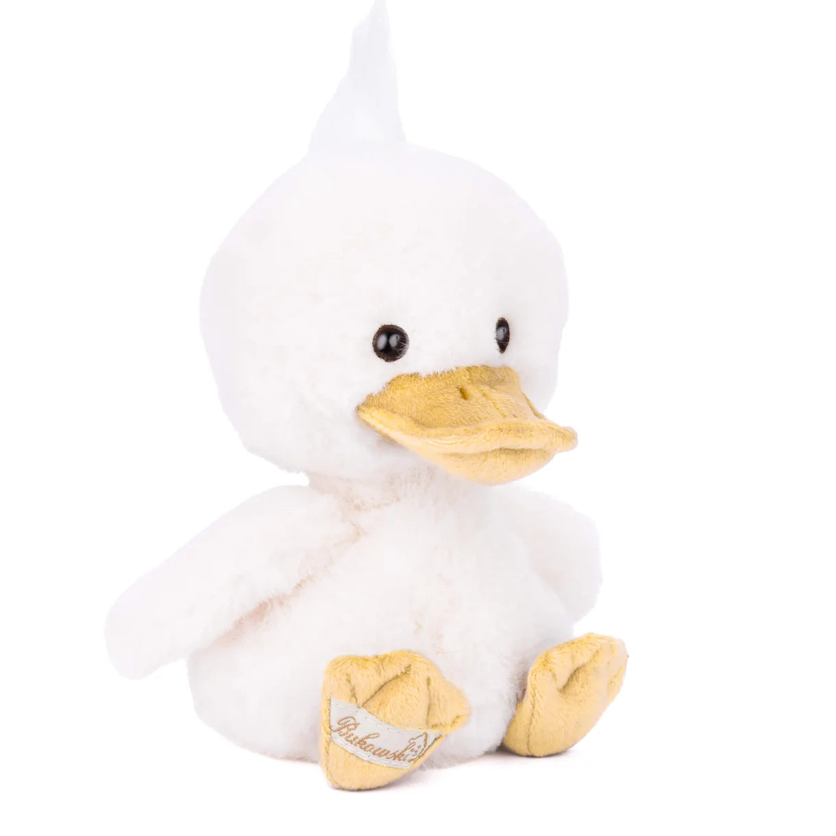 Plush duck toy with a white body and yellow beak and feet with a  Bukowski bear label on a white background