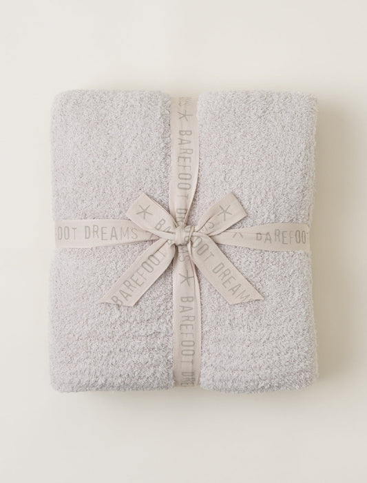Barefoot dreams CozyChic Throw in Stone color folded and packaged with a matching ribbon.