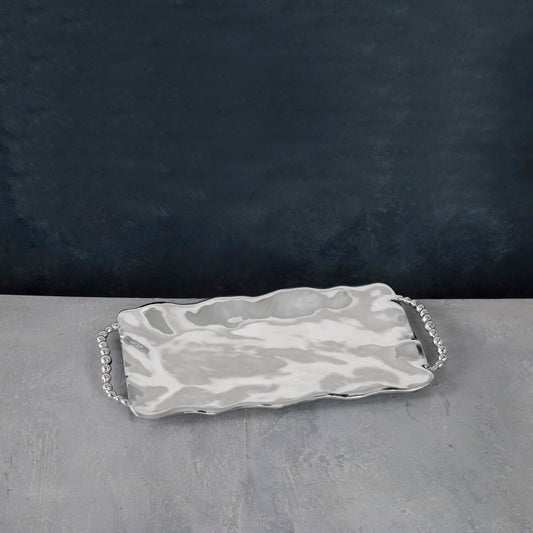 A rectangular serving tray with handles, featuring a pearl-like patterned design.
