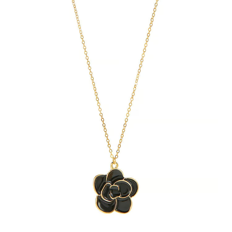Charlie Paige Black Rose Bloom Gold Necklace Black flower pendant on a gold chain against a white background
