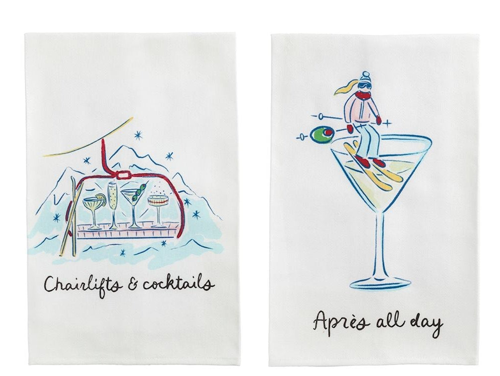 Two mudpie white kitchen towels  each printed with a different cocktail-themed illustration and humorous caption: 'Chairlift & cocktails,' 'Après all day,' 