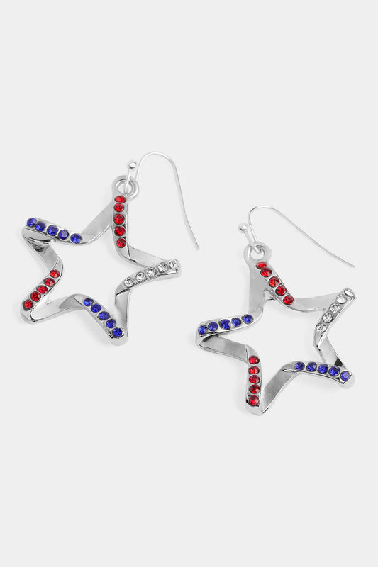 Bent Star-shaped earrings with red, blue, and clear gemstones on a white background by Coco+Carmen Whispers