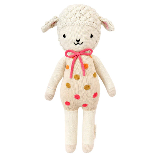 Knitted toy sheep with polka dot body and a pink bow 