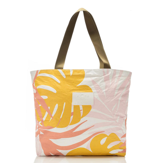 Tote bag with yellow and pink leaf pattern on a white background