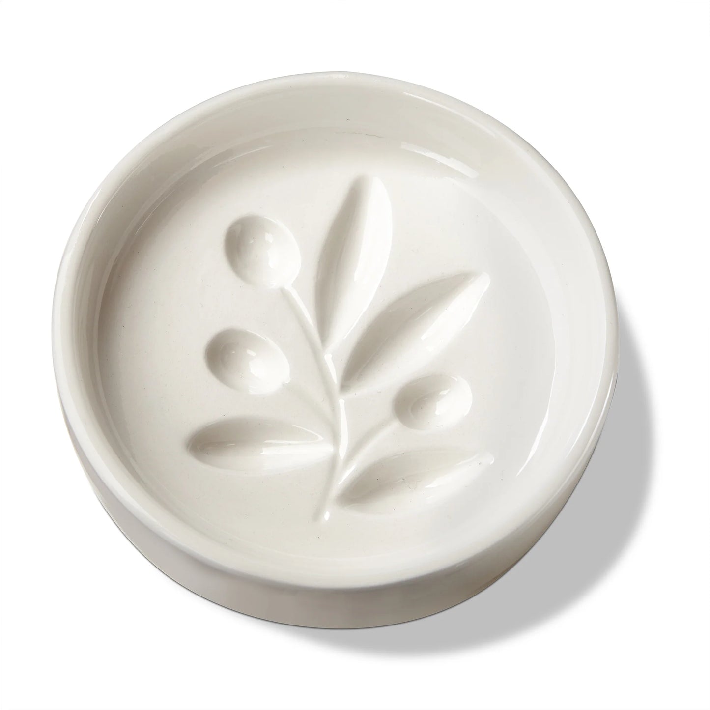 White ceramic dish with leaf design on a white background