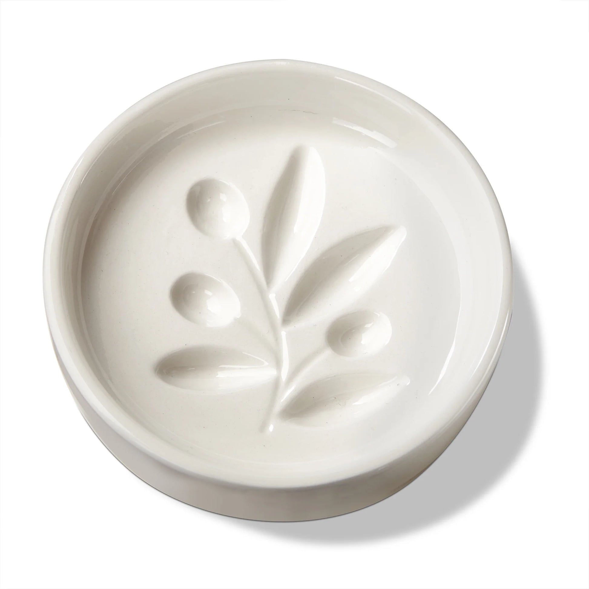 White ceramic dish with leaf design on a white background