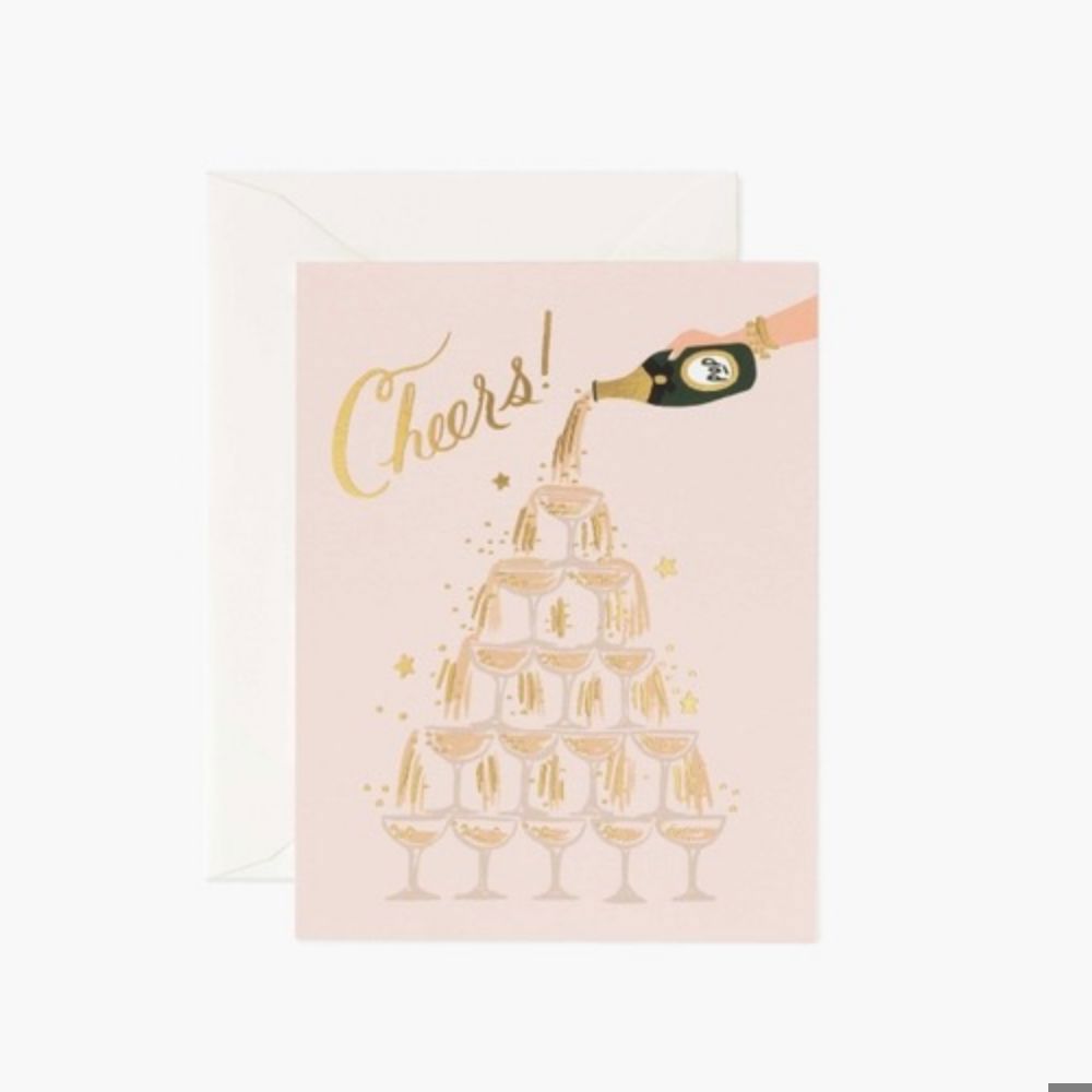 Pink card with a tower of glasses with a cartoon hand poring a black bottle of champaign cascading over the glasses with the script Cheers greeting card by Rifle Paper