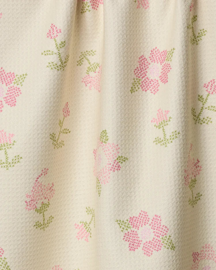 Geometry Cross Stitch Floral patterned fabric with pink flowers and green leaves on a beige background