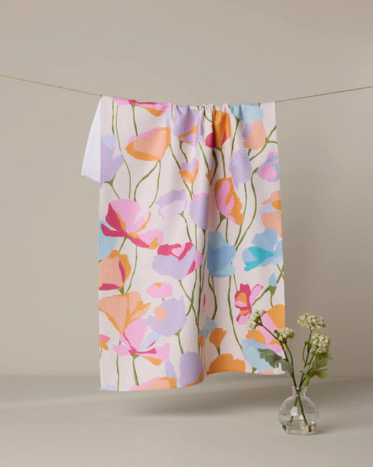 Geometry sunlit garden and Floral patterned towel hanging on a line with a vase of flowers on a neutral background