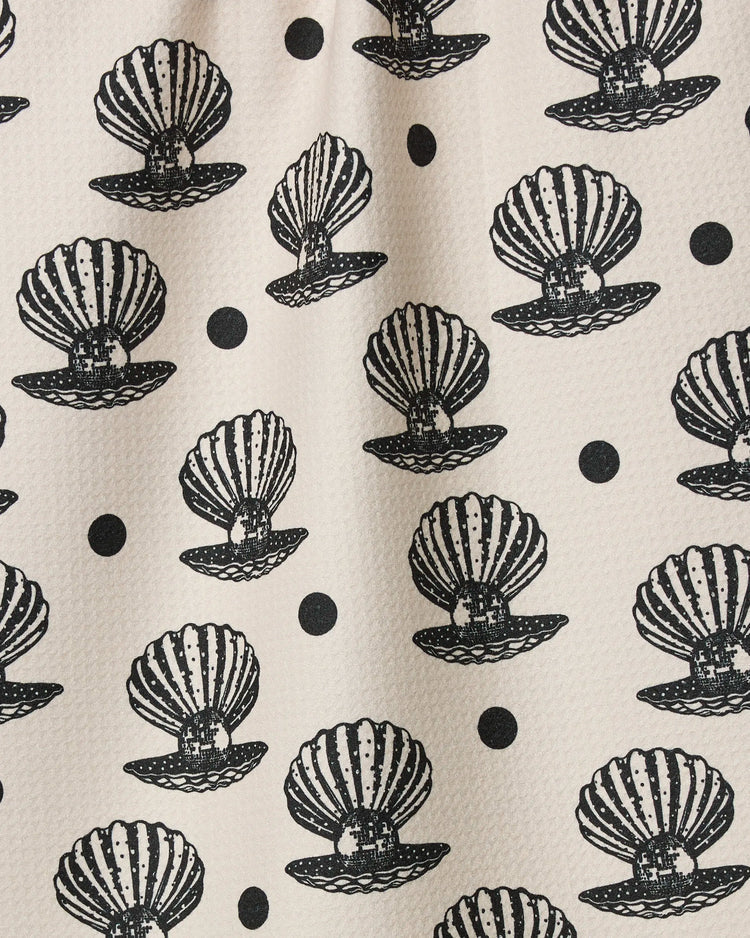 Geometry tea towel with Disco Pearls Pattern of black shell designs on a beige background