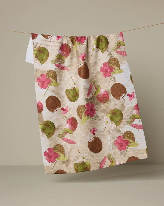 Geometry Vintage Tropi Drinks pattern with Floral and coconut patterned towel hanging on a line against a plain background