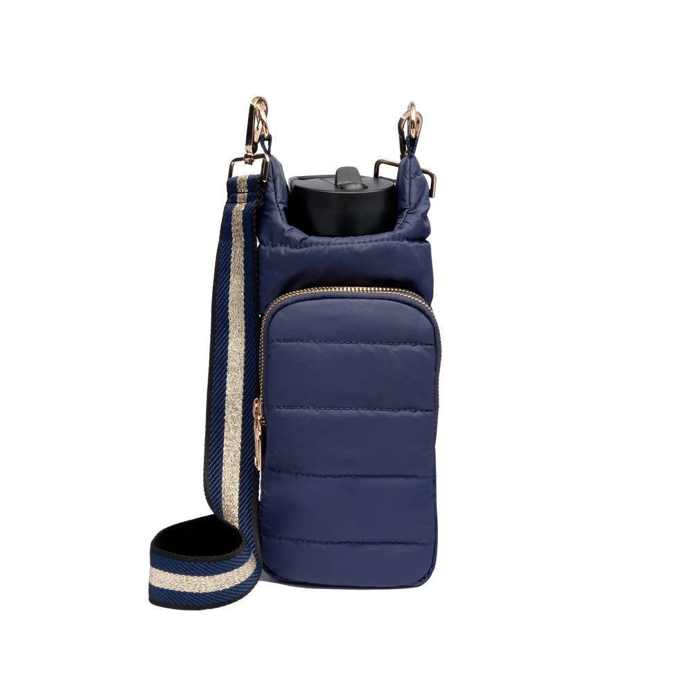 A navy-colored water bottle bag with a gold and navy striped strap, featuring a quilted design and two zippered compartments.