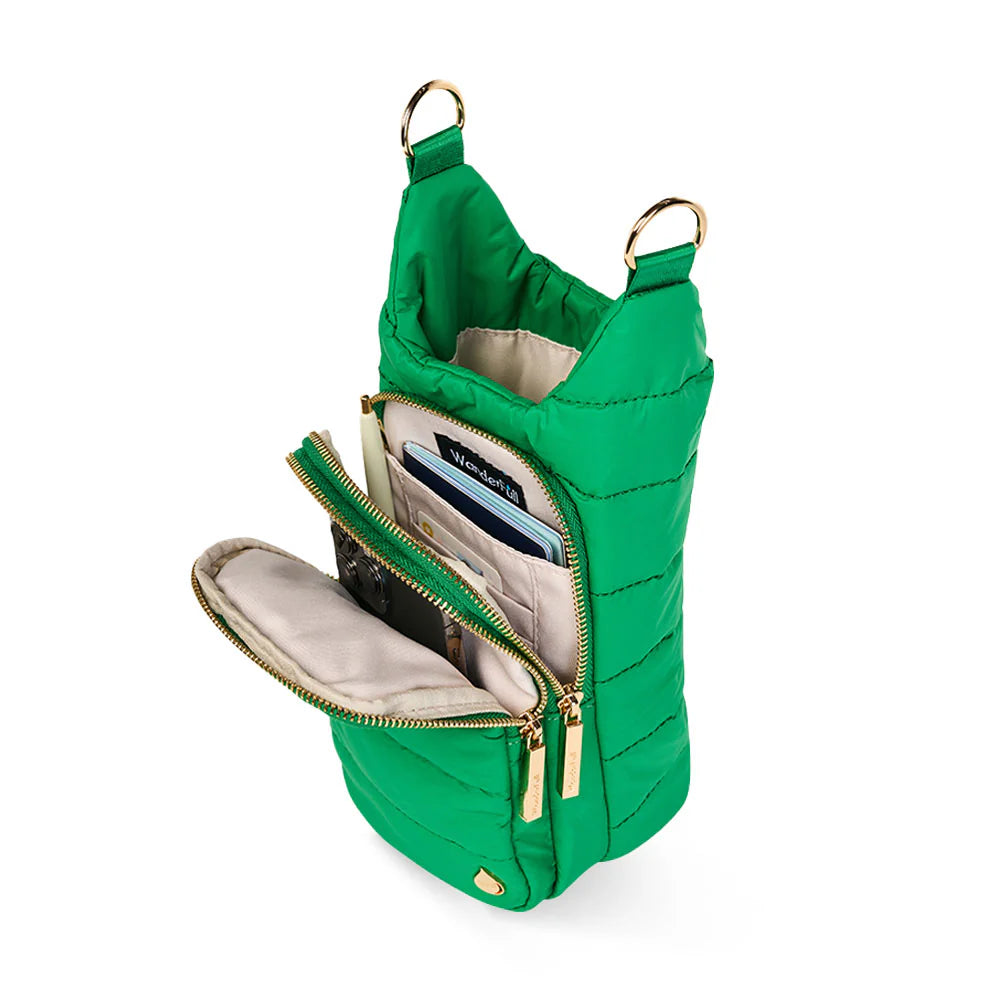 Green quilted handbag with open front pocket on a white background