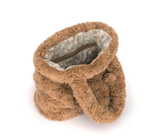 A plush, fuzzy brown bag with a zippered interior and a patterned lining, shown on a plain white background.