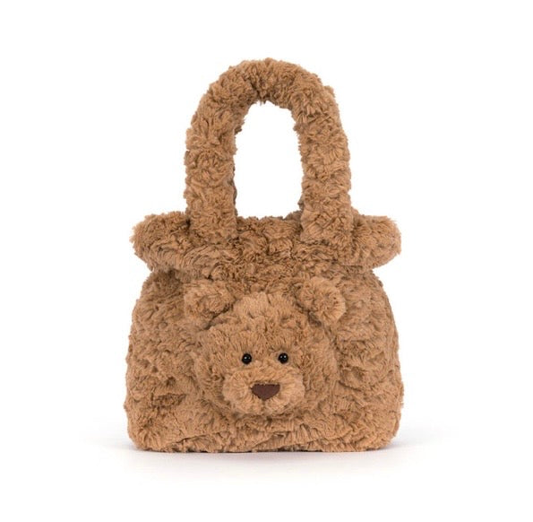A brown teddy bear-shaped handbag with a curly, plush texture and a single top handle, photographed on a clean white background.