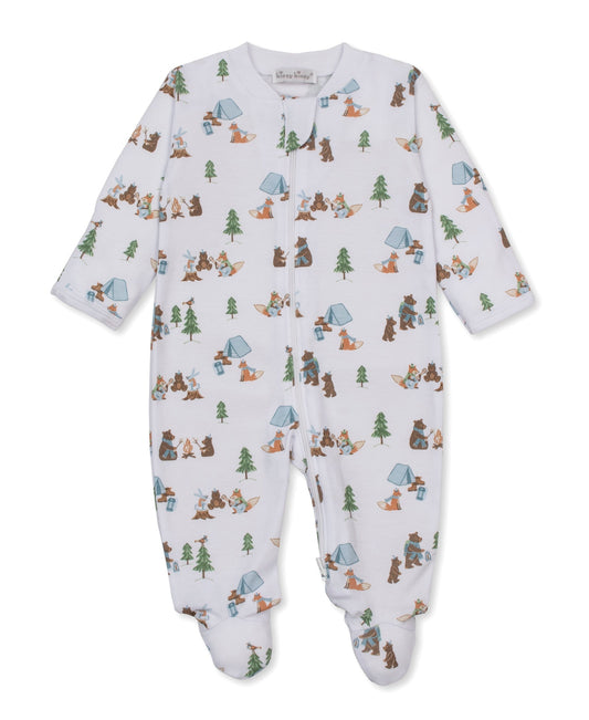 A baby footed sleeper in white with a colorful camping and forest theme print, featuring cartoon bears, trees, and tents.
