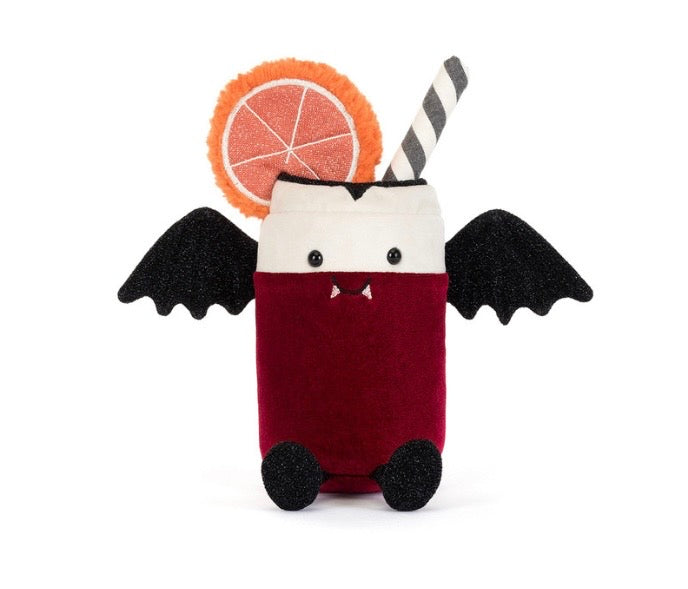 A cute plush toy shaped like a vampire cocktail drink, featuring a deep red body, a white face, black bat wings, a black-and-white striped straw, and a fuzzy orange slice garnish on a white background.