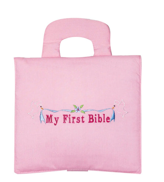 A pink "My First Bible" with a handle on top and decorative elements around the title.
