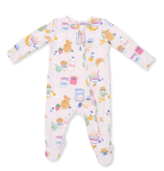 A baby long-sleeve footed sleeper in a very pale pink or off-white color, covered in a colorful cartoon print of breakfast items like eggs, pancakes, milk, and fruit.