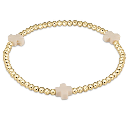 An enewton signature cross gold-colored bracelet with off-white beads and a cross pattern, designed for women.
