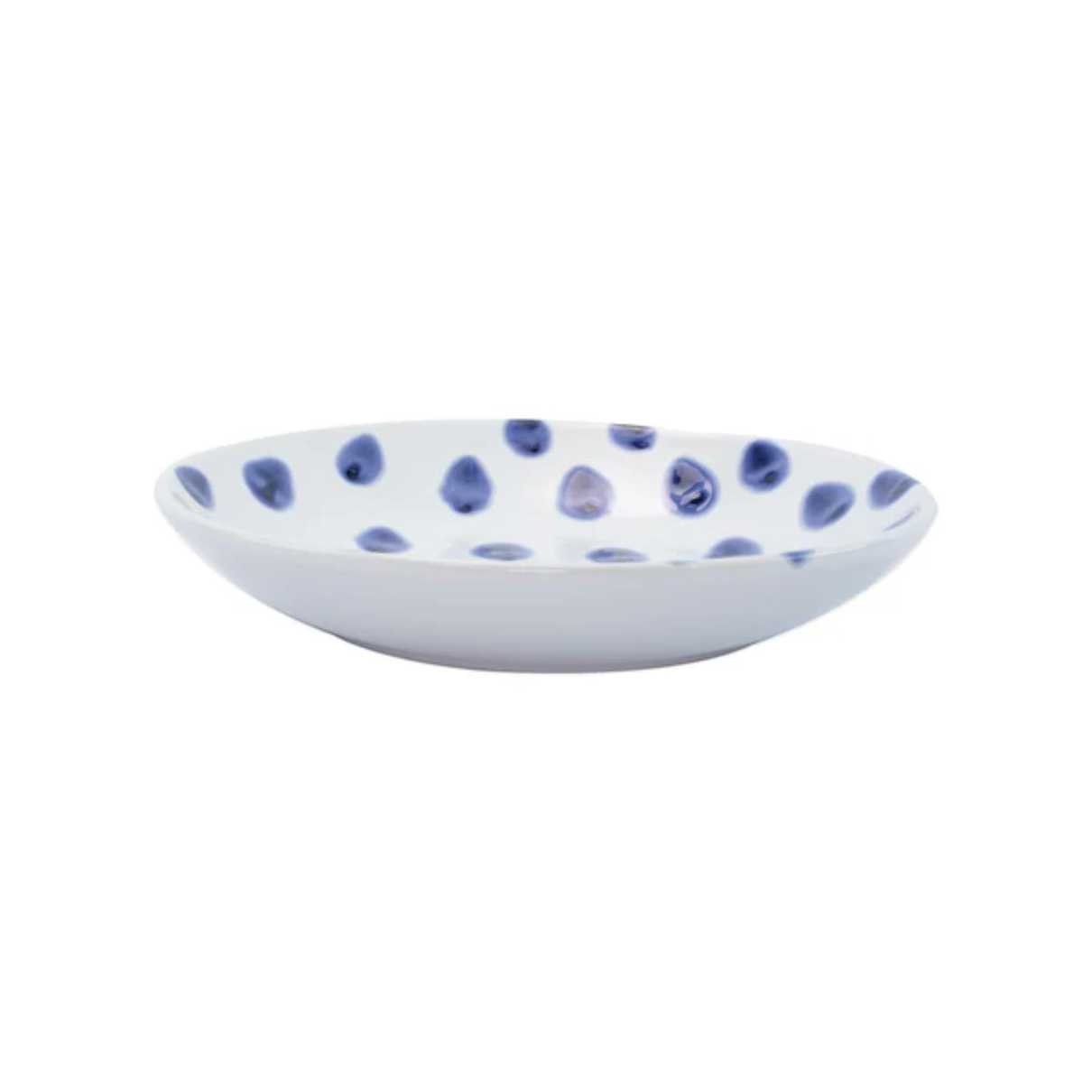 White ceramic bowl with blue polka dot pattern on a white background