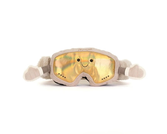 A plush novelty pair of ski goggles with a smiling face on the reflective gold lens, featuring beige faux-fur ears and arms, and the brand name 'Jellycat' printed on the forehead.
