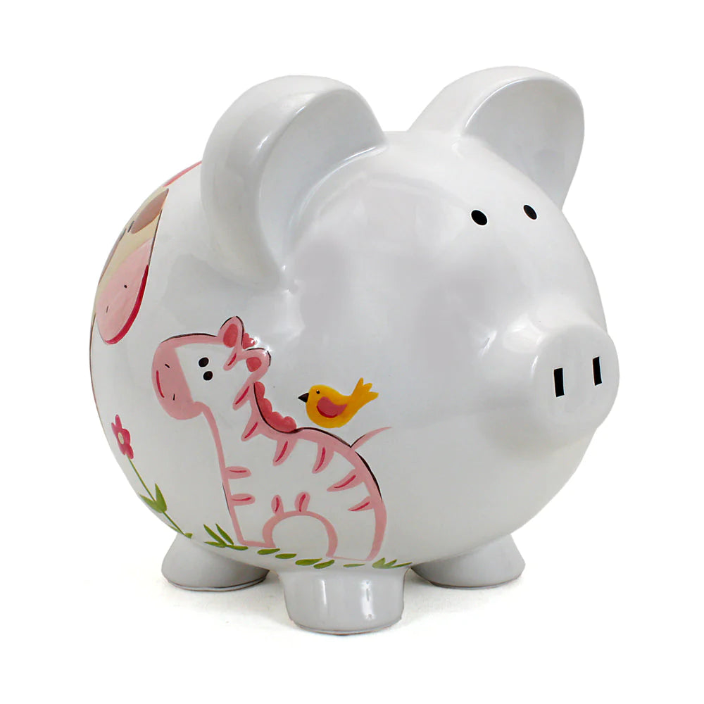 A white ceramic piggy bank painted with a giraffe and monkey