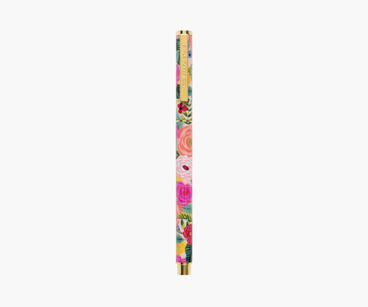 A multicolored floral patterned rollerball writing pen with brass accents.