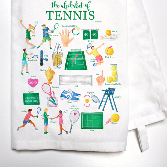 A white cotton kitchen towel with colorful tennis-themed illustrations and text that reads 'the alphabet of TENNIS'.