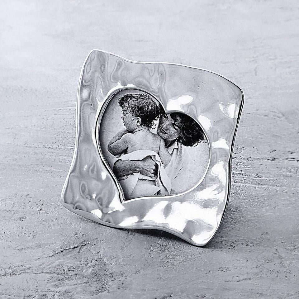 A silver, heart-shaped, handcrafted photo frame by Beatriz Ball