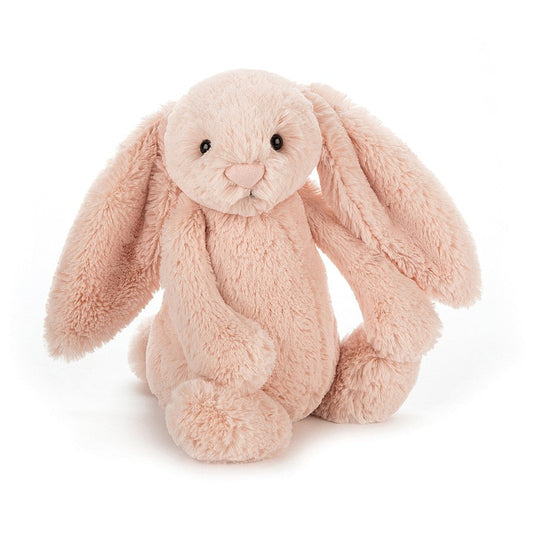 A medium-sized plush toy bunny with a blush pink color and long ears, designed by Jellycat.