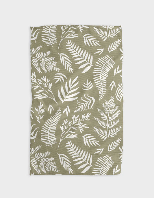 A green tea towel with a white leaf pattern displayed flat.