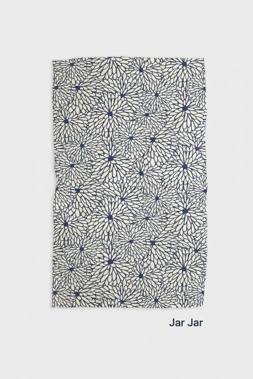 A blue and white geometric patterned Geometry jar jar tea towel laid out flat.