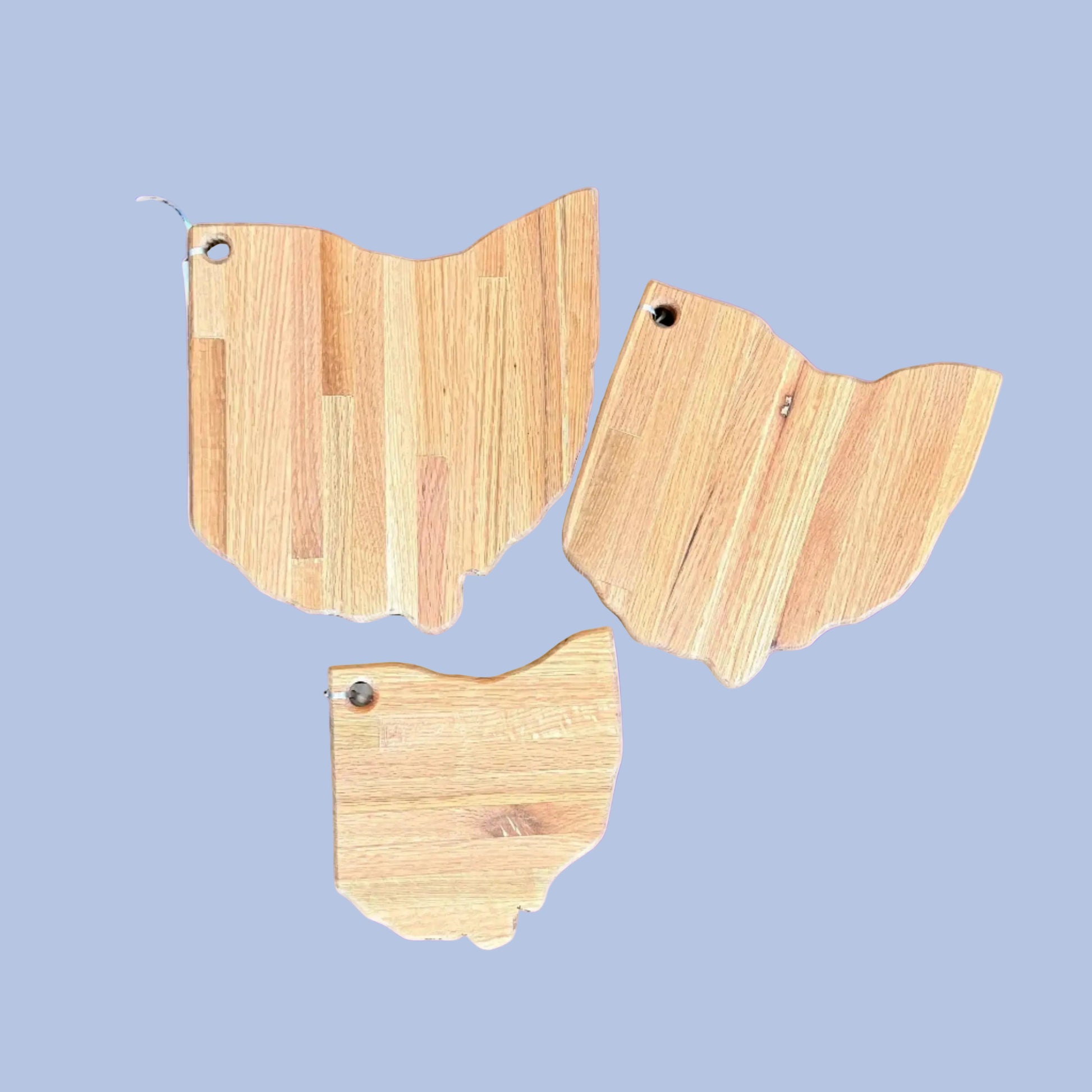 Three wooden cutting boards shaped like the state of Ohio 