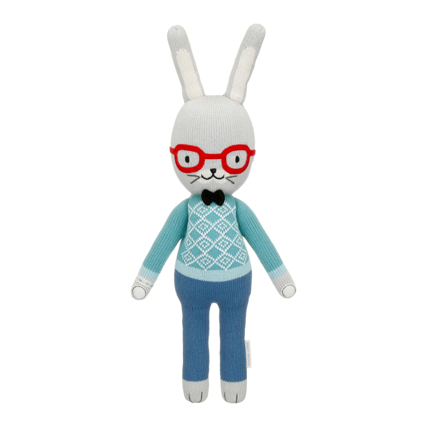 Knitted bunny toy with red glasses, blue sweater, and pants on a white background