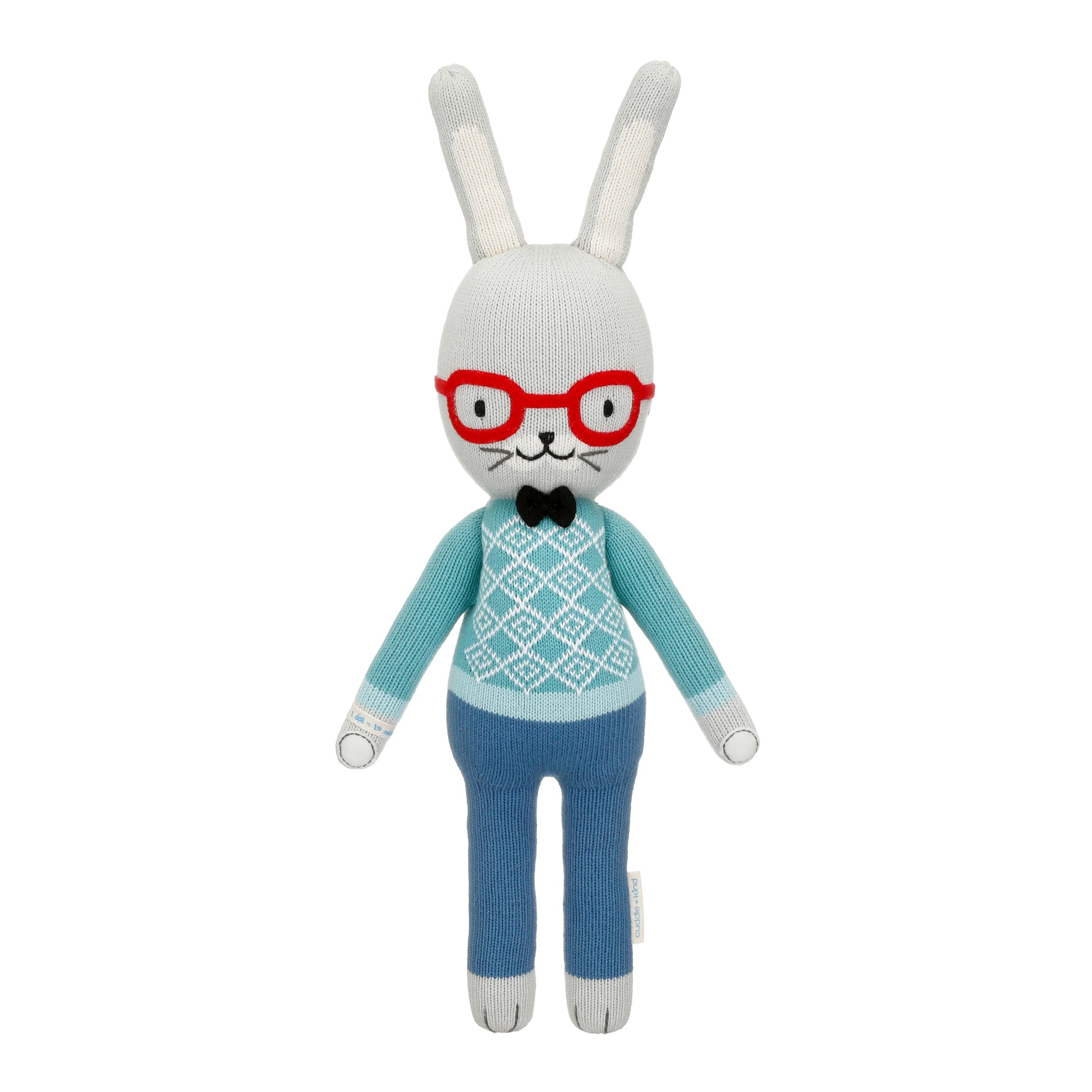 Knitted bunny toy with red glasses, blue sweater, and pants on a white background